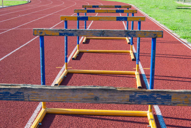 Five worn obstacles on athletics track in a row