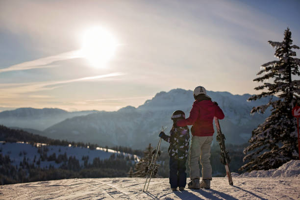 mother and son, preschool child, skiing together on sunset in austrian alps - czech republic ski winter skiing imagens e fotografias de stock