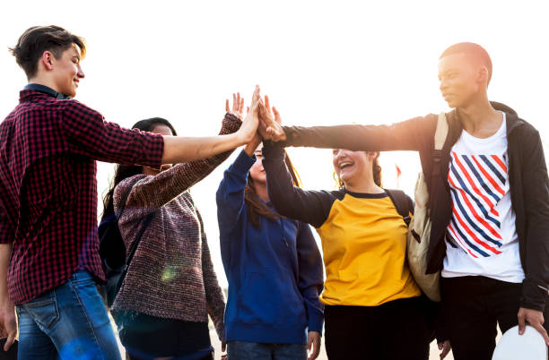 Group of friends all high five together support and teamwork concept Group of friends all high five together support and teamwork concept teenagers only stock pictures, royalty-free photos & images