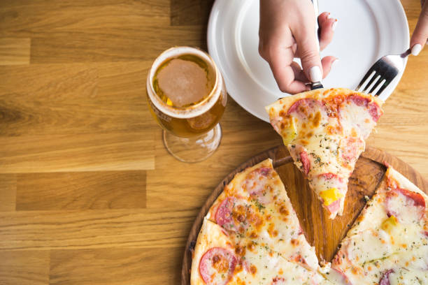 istock hot piece of pizza with cheese 1035576034