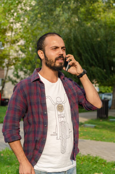 istock The young man is speaking  at his cell phone 1035583328