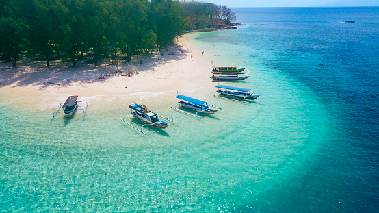 Image of tourist ships anchored on the Gili Rengit beach at Lombok, Indonesia
