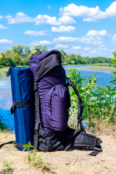 istock Tourist backpack near a river at summer. Hike concept 1035587066