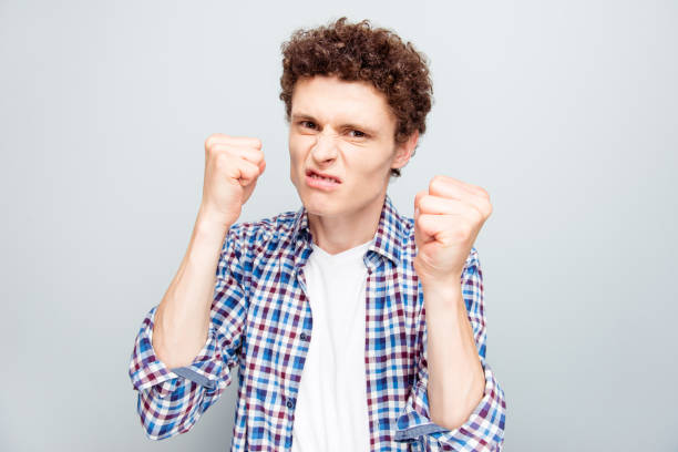 istock Portrait of guy ready for a fight isolated on light gray background 1035587258