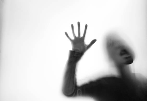 istock A boy trapping behind frosted glass 1035588400