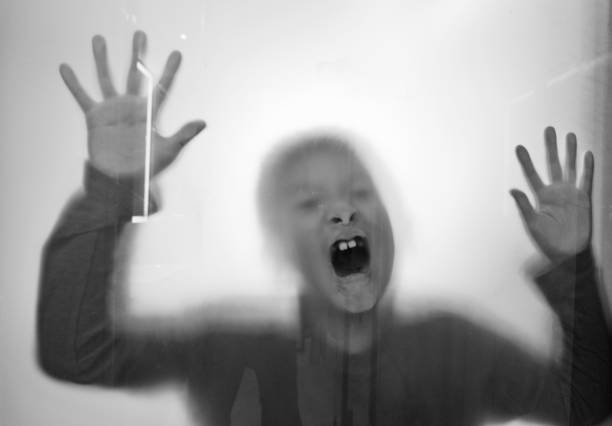 istock A boy trapping behind frosted glass 1035590694
