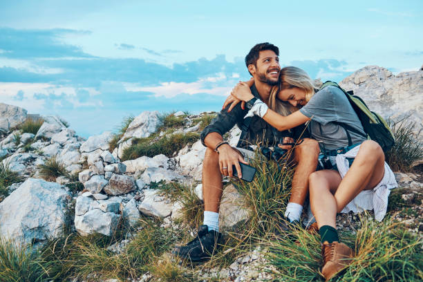 istock playful couple resting from hiking 1035591466