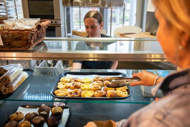 istock Female baker working in a supermarket bakery department 1035592546