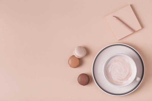 istock Cup of coffee with macaroons on pastel background 1035595528