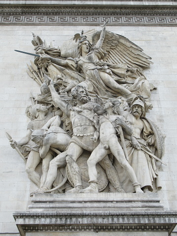 Close-up view of one of the pillar of the Arc de Triomphe in Paris. The winged personification of Liberty rises above volunteers in this sculptural group called Le Départ de 1792 (or La Marseillaise), by François Rude. The group celebrates the cause of the French First Republic during the 10 August uprising.