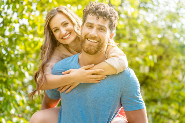istock Husband is carrying his wife on his back being a reliable partner 1035599768