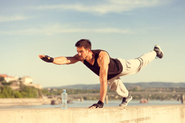 istock fitness man doing push-ups on one arm and one leg 1035600744
