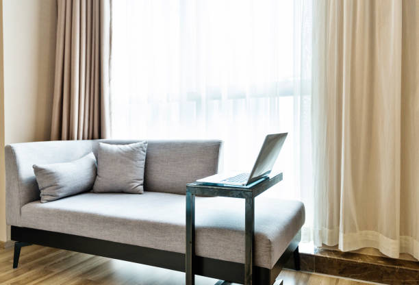 istock Laptop on table near gray sofa 1035603706
