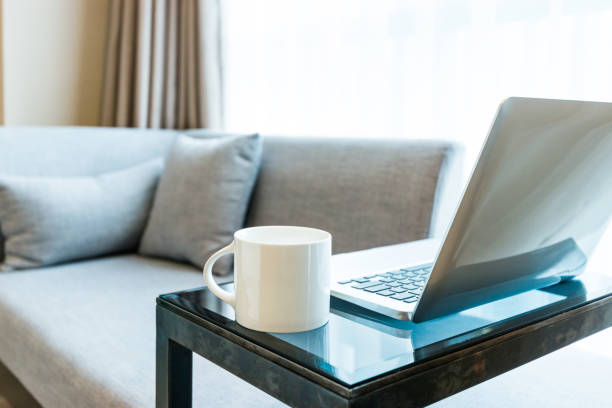 istock Laptop on table near gray sofa 1035603764