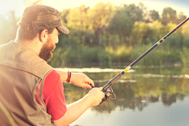 istock Young man fishing on a river 1035609134