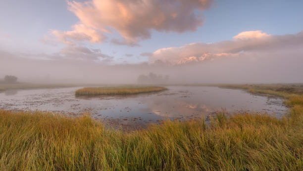 istock lake fog mountains island reflection sunrise 1035609426