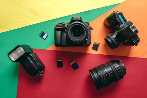 Diverese photography equipment against a colorful background