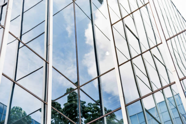 istock Blue sky and clouds reflecting at office building wall 1035611812