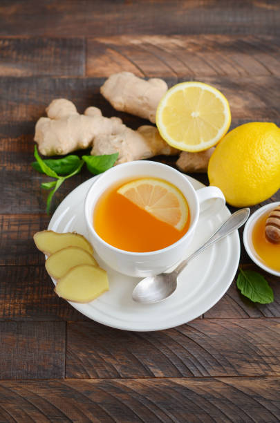 istock Ginger root tea with lemon and honey on wooden background. 1035612406