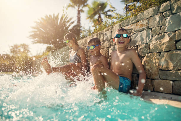 istock Kids playing in swimming pool 1035618796