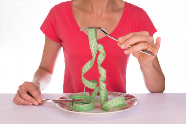 istock The girl with a fork and knife on a plate meter 1035624404