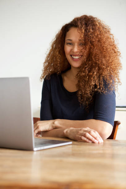 istock young woman sitting with laptop 1035624936