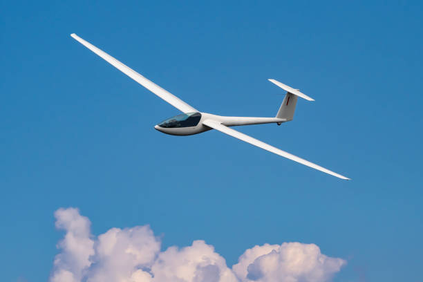 Glider plane flying Glider plane flying in the cloudy sky towing photos stock pictures, royalty-free photos & images