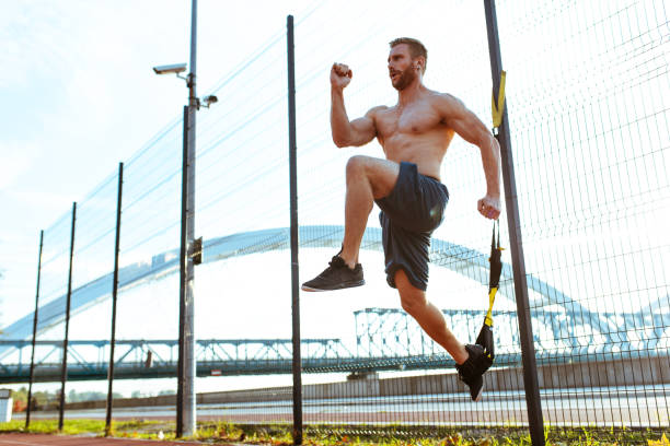 istock Attractive man exercising suspension training at dawn 1035631338