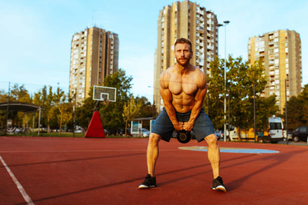 istock Fitness young man training with kettlebell at dawn 1035632344