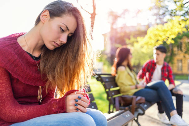 istock Depressed woman sitting in the park 1035636382