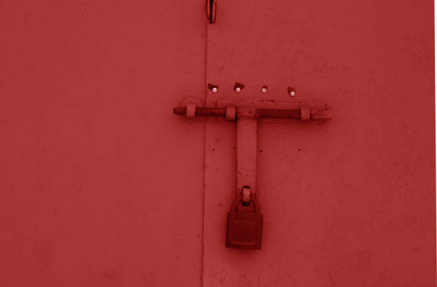 istock Old padlock on metal gate in red color. 1035636398
