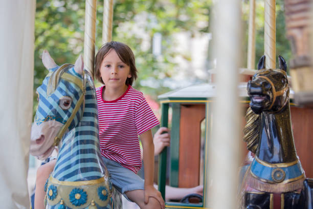 istock Children going on Merry Go Round, kids play on carousel 1035639092