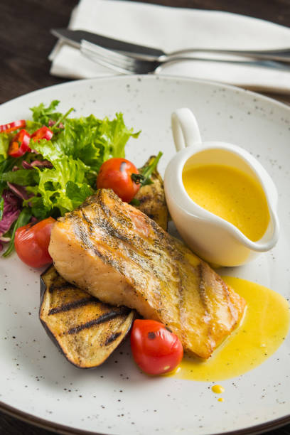 istock yummy fish steak with vegetables 1035642960