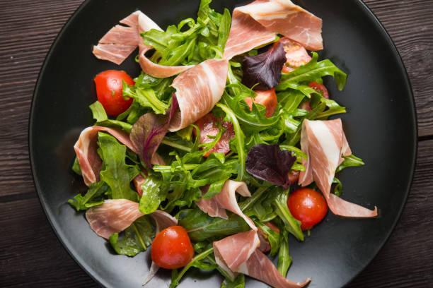 istock Fresh salad with prosciutto, arugula and tomato 1035643310