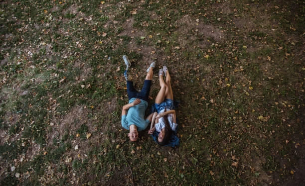 istock Couple lying on grass in park 1035643568