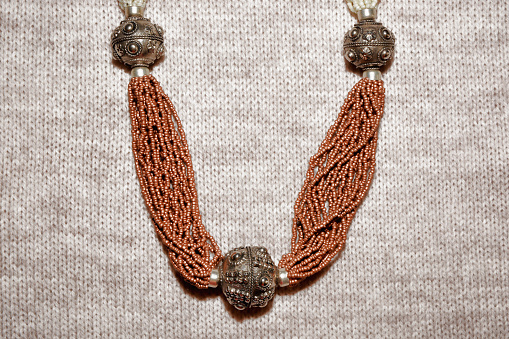 Egyptian jewelry beaded necklace and metal on burlap background