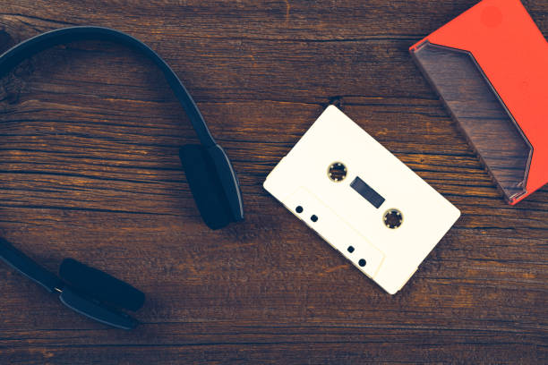 istock Compact Audio Cassette Tape on Wooden Background with Copy Space 1035646390