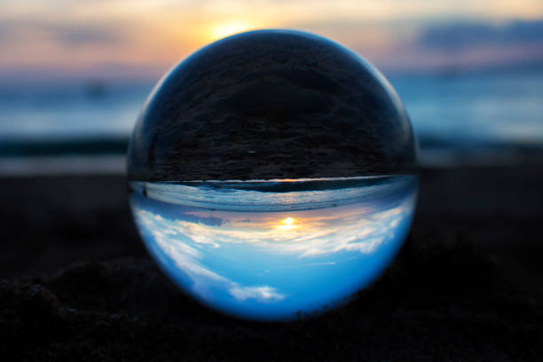 istock Sunset with Clouds Light and Ocean Captured in Glass Ball 1035646840