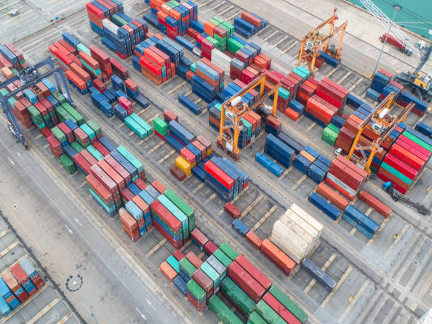 istock Container ship in export and import business and logistics. Shipping cargo to harbor by crane. Water transport International. Aerial view and top view. 1035649974