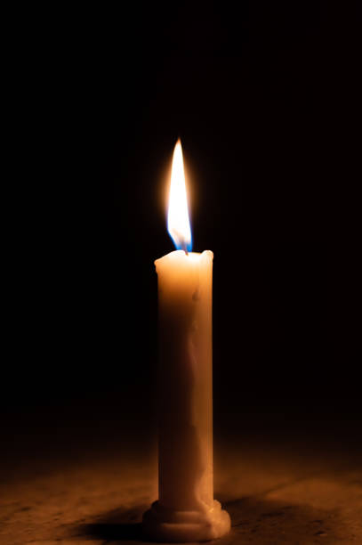 istock A table lit by a candle in a dark room 1035650354