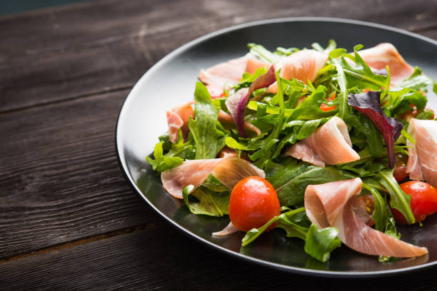 istock Fresh salad with prosciutto, arugula and tomato 1035650432