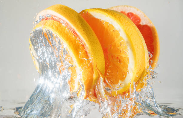 istock Grapefruit and orange coming out from water. Suitable for advertisement. 1035650532