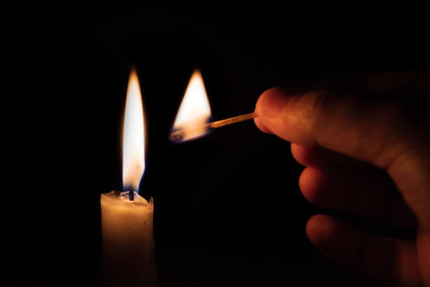 istock Person lighting a candle with a matchstick 1035650700