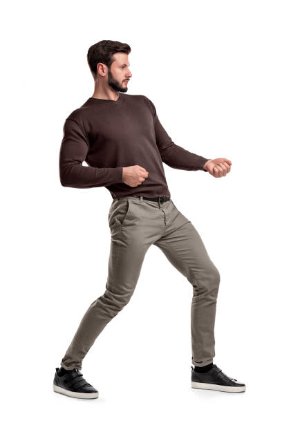 istock A bearded man a jumper and pants tries to pull a strong invisible rope on a white background. 1035654280