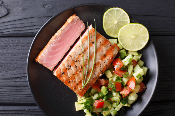 istock Mexican tuna steak with avocado cucumber salsa closeup. horizontal view from above 1035659186