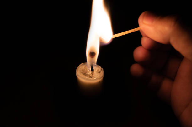 istock Person lighting a candle with a matchstick. 1035662322