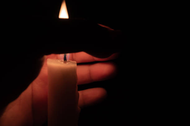 istock A hand protecting a candle against wind 1035662358