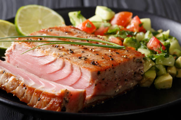 istock Lime Grilled Tuna with Avocado Cucumber Salsa closeup on a plate. horizontal 1035662678