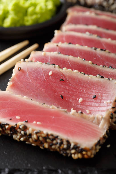 istock Gourmet meal: a beautiful tuna steak in sesame and wasabi macro. vertical 1035663368