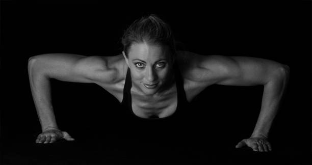 istock Fit woman with shaped muscles in push-up position in artistic conversion 1035668720